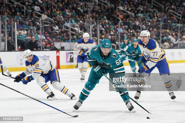 Mike Hoffman of the San Jose Sharks skates with the puck against the Buffalo Sabres in the third period at SAP Center on December 27, 2024 in San...