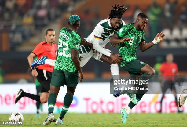 André-Frank Zambo Anguissa of Cameroon competes for the ball with Frank Onyeka and Kenneth Omeruo of Nigeria ,during the Total Energies CAF Africa...