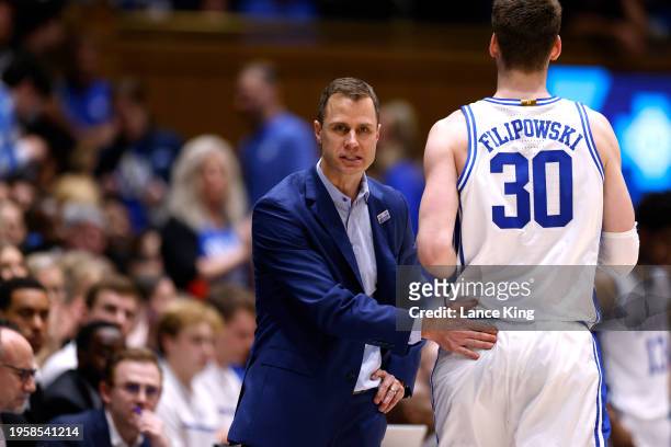 Head coach Jon Scheyer of the Duke Blue Devils talks with Kyle Filipowski during the second half of the game against the Clemson Tigers at Cameron...