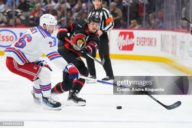 Thomas Chabot of the Ottawa Senators shoots the puck, breaking the stick of Jimmy Vesey of the New York Rangers during the first period at Canadian...