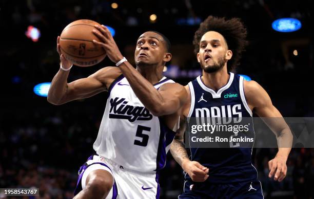 De'Aaron Fox of the Sacramento Kings drives inside past Dereck Lively II of the Dallas Mavericks in the first half at American Airlines Center on...