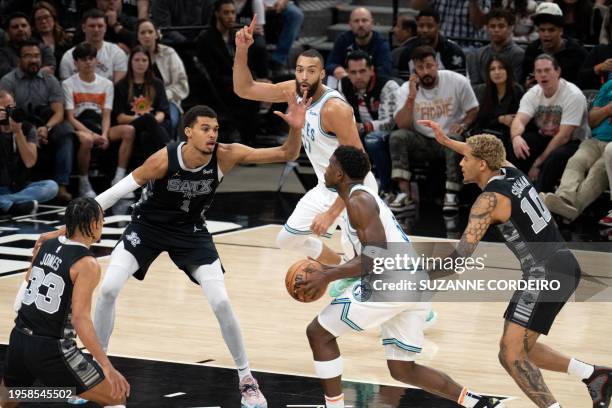 Minnesota Timberwolves' US guard Anthony Edwards attempts a shot over San Antonio Spurs' French forward Victor Wembanyama during the NBA game between...