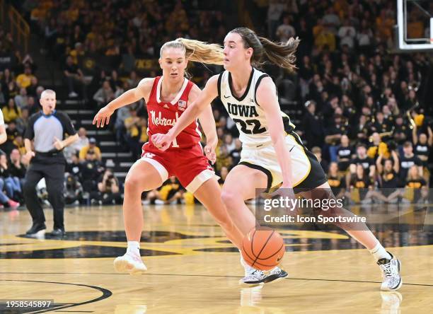 Iowa guard Caitlin Clark drives to the basket as Nebraska guard Jay Shelley defends during a women's college basketball game between the Nebraska...