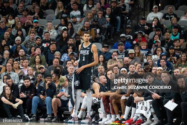 San Antonio Spurs' French forward Victor Wembanyama stands by the sideline during the NBA game between the San Antonio Spurs and the Minnesota...