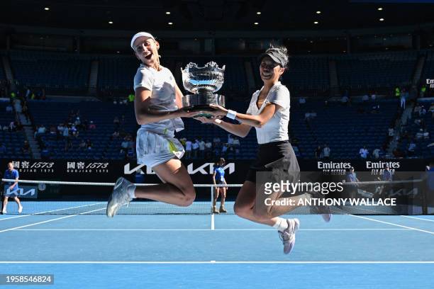 Taiwan's Su-wei Hsieh and Belgium's Elise Mertens jump with the trophy after victory against Ukraine's Lyudmyla Kichenok and Latvia's Jelena...