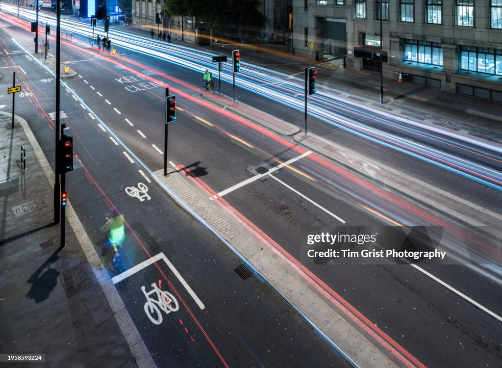 Fast Moving Traffic on a Busy City Street at Night with Light Trails.