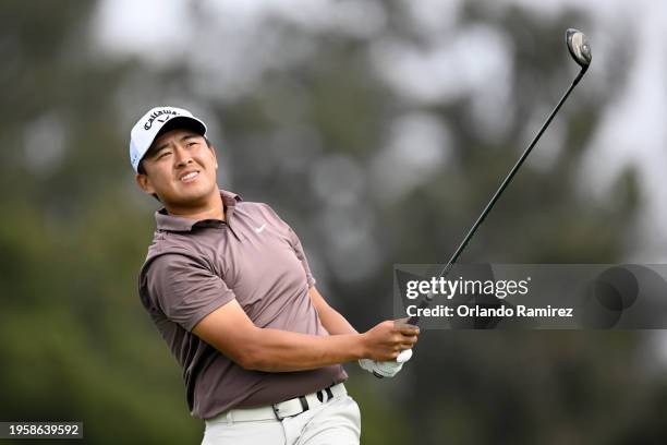 Kevin Yu of Taiwan hits his shot from the third tee during the first round of the Farmers Insurance Open on the Torrey Pines North Course on January...