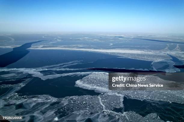 Aerial view of cracks appearing on the surface of the frozen Qinghai Lake under the influence of strong winds on January 24, 2024 in Hainan Tibetan...