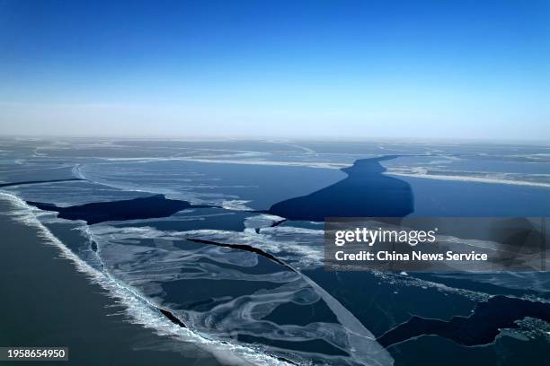 Aerial view of cracks appearing on the surface of the frozen Qinghai Lake under the influence of strong winds on January 24, 2024 in Hainan Tibetan...