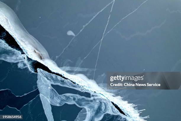 Aerial view of cracks appearing on the surface of the frozen Qinghai Lake under the influence of strong winds on January 24, 2024 in Hainan Tibetan...