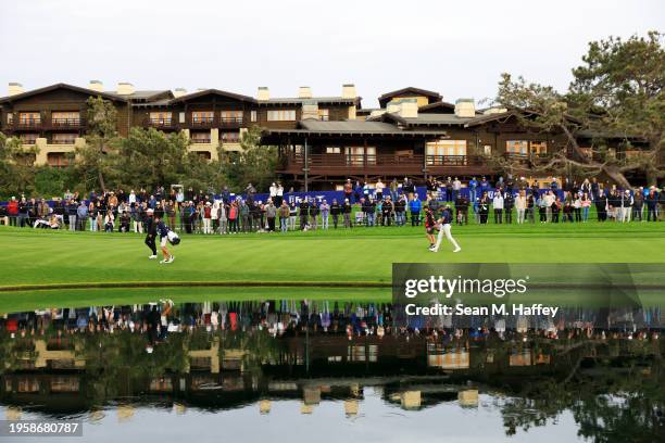 Xander Schauffele of the United States and Tony Finau of the United States walk on the 18th hole during the first round of the Farmers Insurance Open...