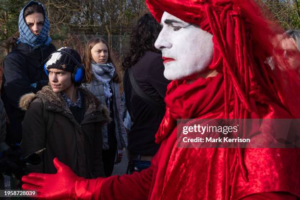 Greta Thunberg watches Extinction Rebellion Red Rebels at a protest against private jet flights and the proposed expansion of Farnborough Airport on...