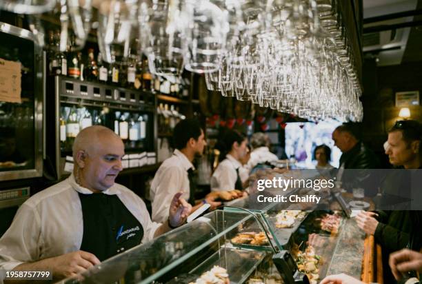 locals enjoying pintxos( pincho or tapas) in san sebastián,basque,spain - san sebastián spanien stock-fotos und bilder