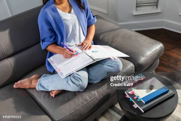 young asian woman studying on sofa, writing in notebook - color coded stock pictures, royalty-free photos & images