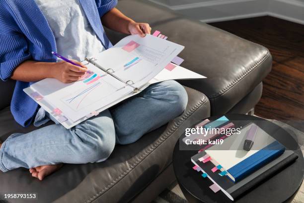 young asian woman studying on sofa, writing in notebook - color coded stock pictures, royalty-free photos & images