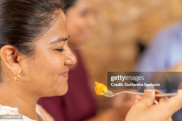 woman eating mashed sweet potato - mashed sweet potato stock pictures, royalty-free photos & images