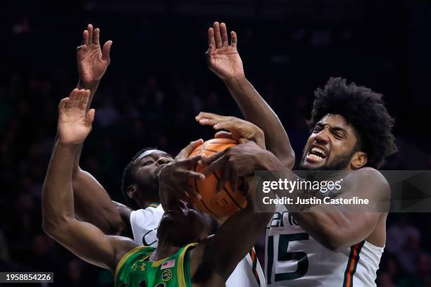 Norchad Omier of the Miami Hurricanes rebounds the ball over Markus Burton of the Notre Dame Fighting Irish during the second half at Joyce Center on...