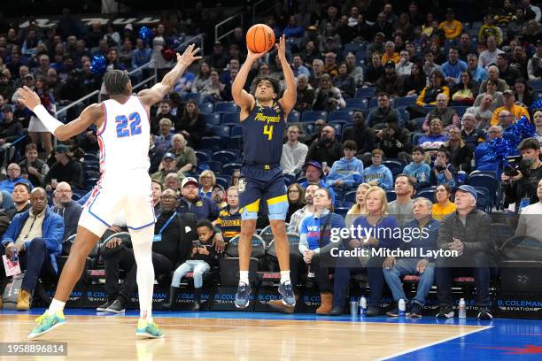 Stevie Mitchell of the Marquette Golden Eagles takes a jump shot against Elijah Fisher of the DePaul Blue Demons in the first half during a college...