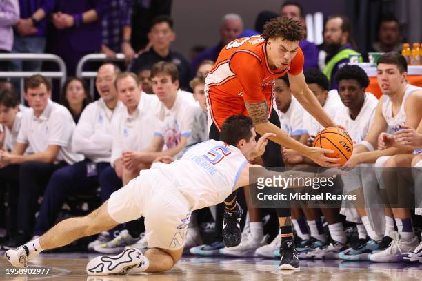 Ryan Langborg of the Northwestern Wildcats dives for a loose ball against Coleman Hawkins of the Illinois Fighting Illini during the first half at...