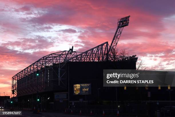 The sun rises behind the stadium ahead of the English FA Cup fourth round football match between West Bromwich Albion and Wolverhampton Wanderers at...