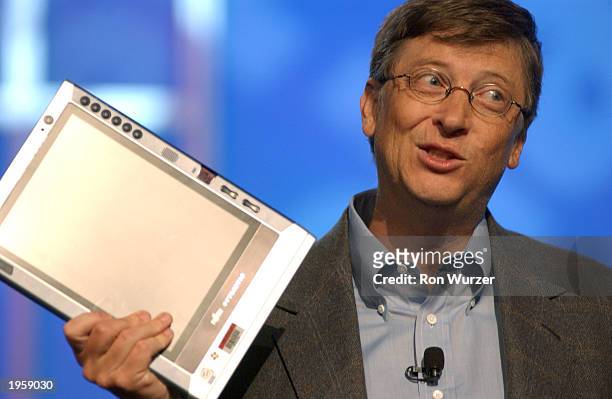 Microsoft Chairman Bill Gates holds a tablet PC as he speaks about newspapers and technology at the annual Newspaper Association of America's...