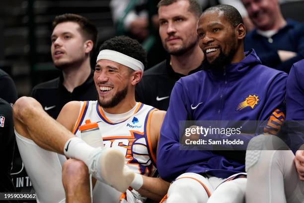 Devin Booker and Kevin Durant of the Phoenix Suns watch the second half of the game against the Dallas Mavericks from their bench at American...