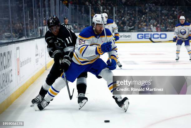 Alex Tuch of the Buffalo Sabres skates the puck against Anze Kopitar of the Los Angeles Kings in the first period at Crypto.com Arena on January 24,...