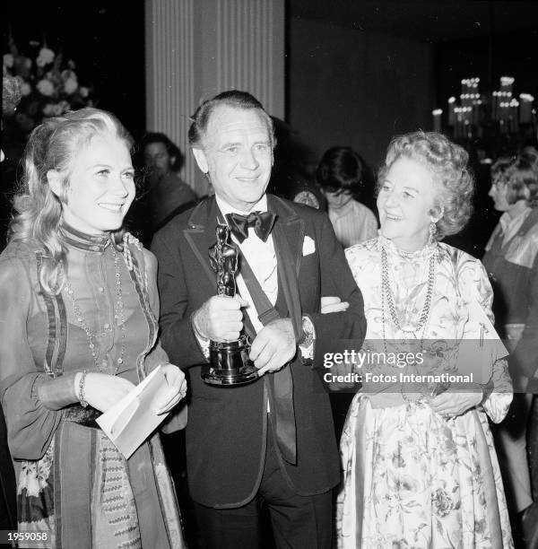 British actor Sir John Mills with his wife, Mary , and daugher, Juliet, at the Academy Awards, Los Angeles, April 15, 1971. He holds his Oscar for...