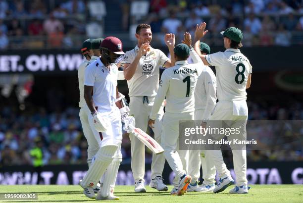 Josh Hazlewood of Australia celebrates with team mates after taking the wicket of Kraigg Brathwaite of the West Indies during day one of the Second...