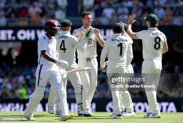 Josh Hazlewood of Australia celebrates with team mates after taking the wicket of Kraigg Brathwaite of the West Indies during day one of the Second...