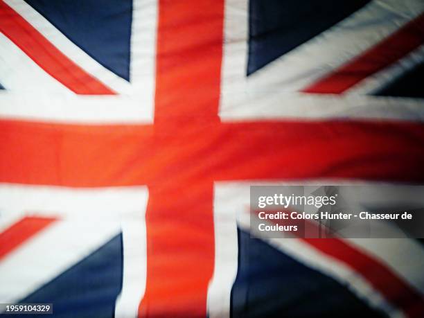 close-up of the united kingdom flag with a blur effect. natural, slightly saturated colors. sunlight. - british flag icon stock pictures, royalty-free photos & images