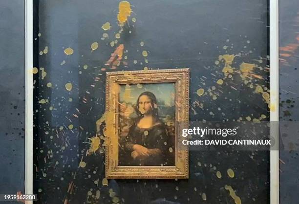 This image grab taken from AFPTV footage shows Leonardo Da Vinci's "Mona Lisa" painting doused in soup after two environmental activists from the...