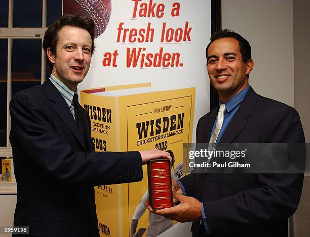 Tim De Lisle editor of the 140th edition of the Wisden Cricketers' Almanac presents England Cricketer Adam Hollioake with a special copy of the...