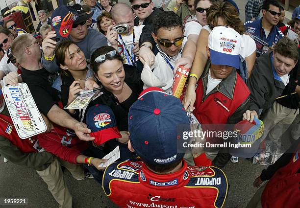 Fans press to get an autograph and just a closer look of Jeff Gordon, driver of the DuPont Chevrolet during qualifying for the NASCAR Winston Cup...