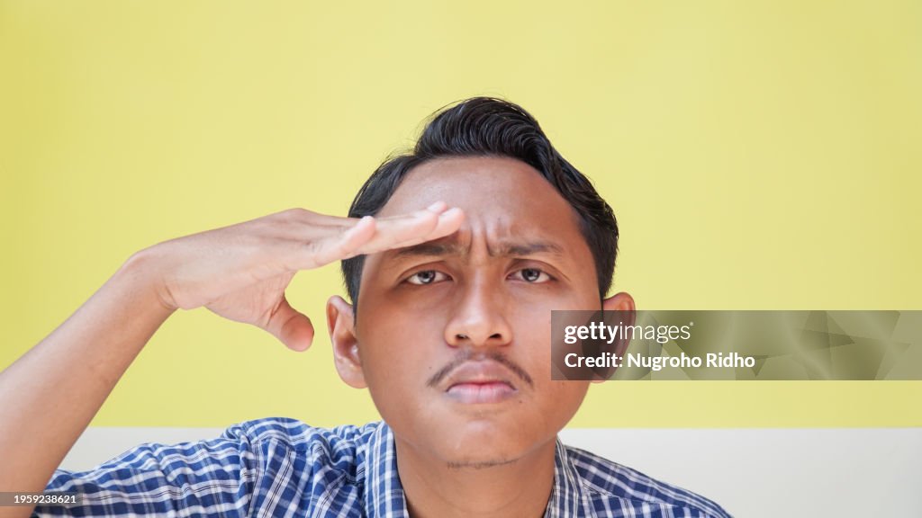 Man Squinting Eyes while Putting Hand on Forehead