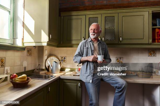 happy mature man day dreaming during coffee time at home. - relax stock pictures, royalty-free photos & images