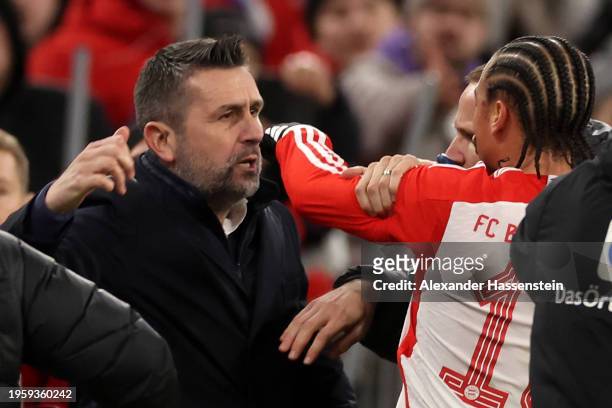 Nenad Bjelica, Head Coach of 1.FC Union Berlin, and Leroy Sane of Bayern Munich clash during the Bundesliga match between FC Bayern München and 1. FC...