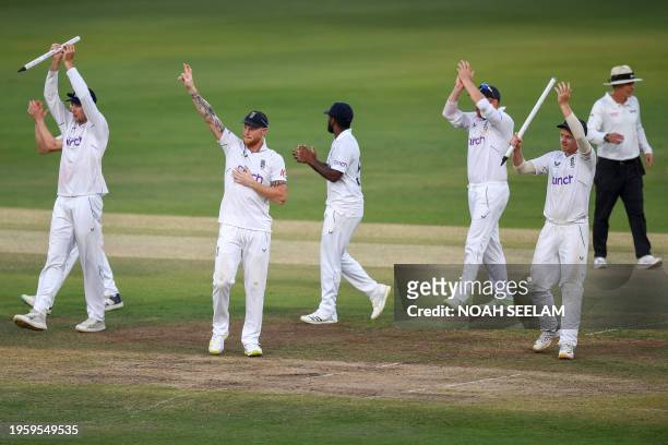 England's captain Ben Stokes and his teammates celebrate after winning the first Test cricket match between India and England at the Rajiv Gandhi...