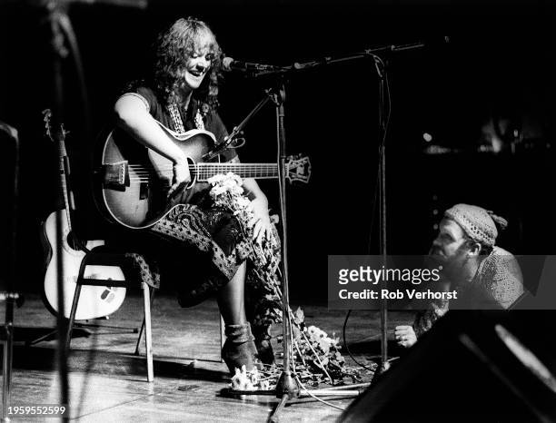 Melanie is watched by a fan leaning on the stage at the front of the audience as she performs at Folk Festival, de Doelen, Rotterdam, Netherlands,...