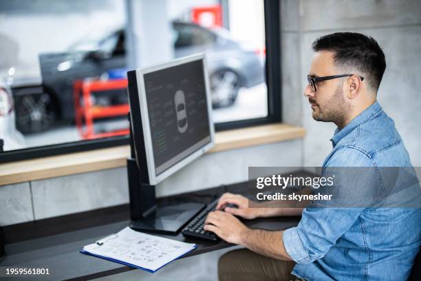 manager of auto repair shop using pc in the office. - computer repairman stock pictures, royalty-free photos & images