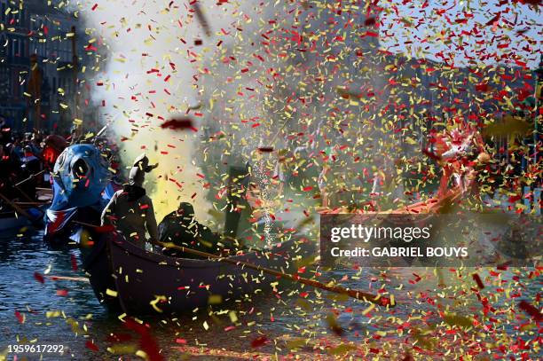 Confettis explode as decorated boats sail on the Grand Canal during the traditional parade of the Coordination of Venetian Rowing Associations, as...