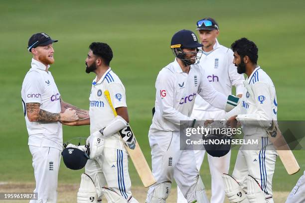 England's captain Ben Stokes and his teammate Ben Foakes shake hands with India's Mohammed Siraj and Jasprit Bumrah at the end of the first Test...