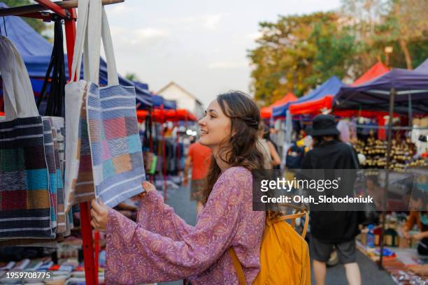 woman exploring street  market in luang prabang - twilight market stock pictures, royalty-free photos & images