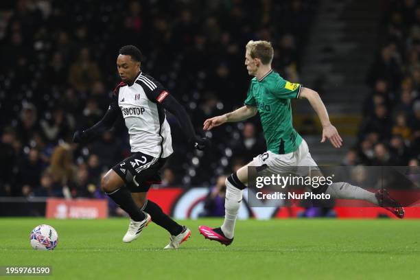 Kenny Tete of Fulham is being chased by Anthony Gordon of Newcastle United during the FA Cup Fourth Round match between Fulham and Newcastle United...