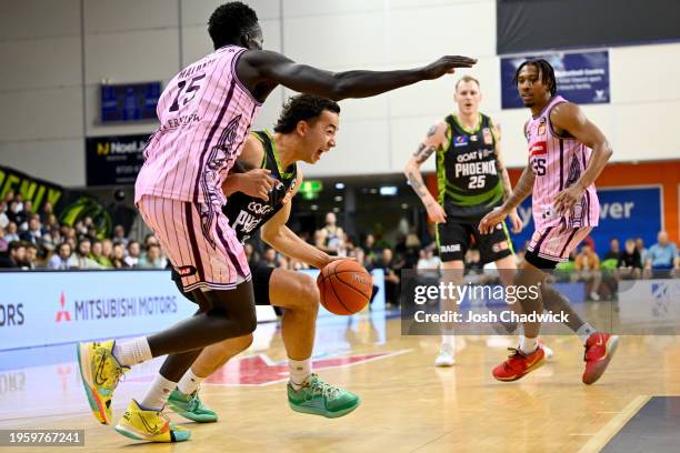 Owen Foxwell of the Phoenix drives to the basket under pressure from Makuach Maluach of the Kings during the round 17 NBL match between South East...