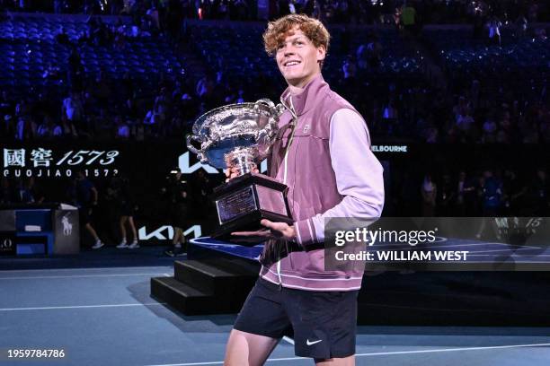 Italy's Jannik Sinner celebrates with the Norman Brookes Challenge Cup after victory against Russia's Daniil Medvedev during their men's singles...