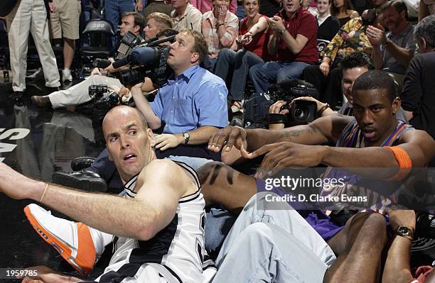 Amare Stoudemire of the Phoenix Suns and Danny Ferry of the San Antonio Spurs fall out of bounds in Game two of the Western Conference Quarterfinals...
