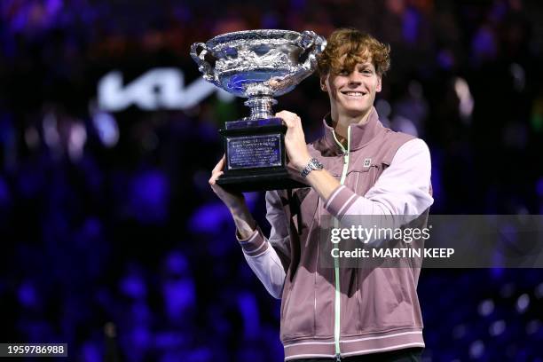 Italy's Jannik Sinner poses with the Norman Brookes Challenge Cup trophy after defeating Russia's Daniil Medvedev in the men's singles final match on...