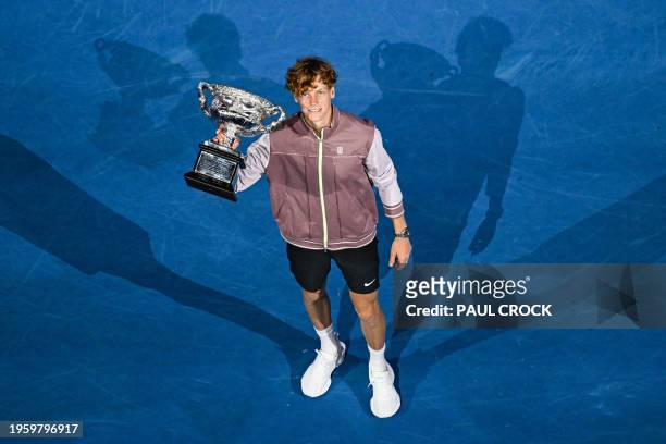 Italy's Jannik Sinner celebrates with the Norman Brookes Challenge Cup trophy after defeating Russia's Daniil Medvedev in the men's singles final...