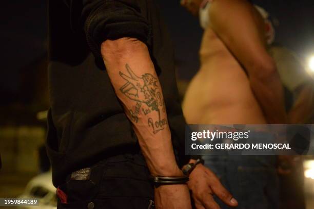 Man with a tattoo related to Los Lobos criminal gang is arrested during an operation in which three people were detained in Guayaquil, Ecuador on...